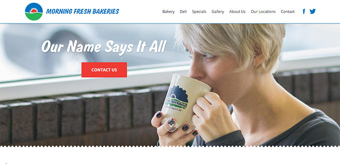 Woman drinks coffee and looks out window.