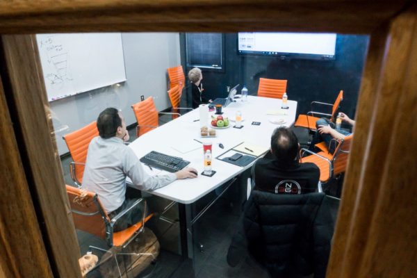 A website team gathers around a table.