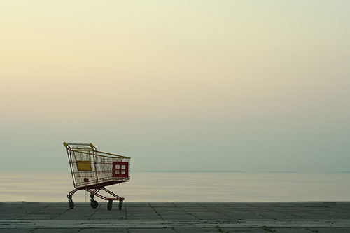 abandoned shopping cart at seaside