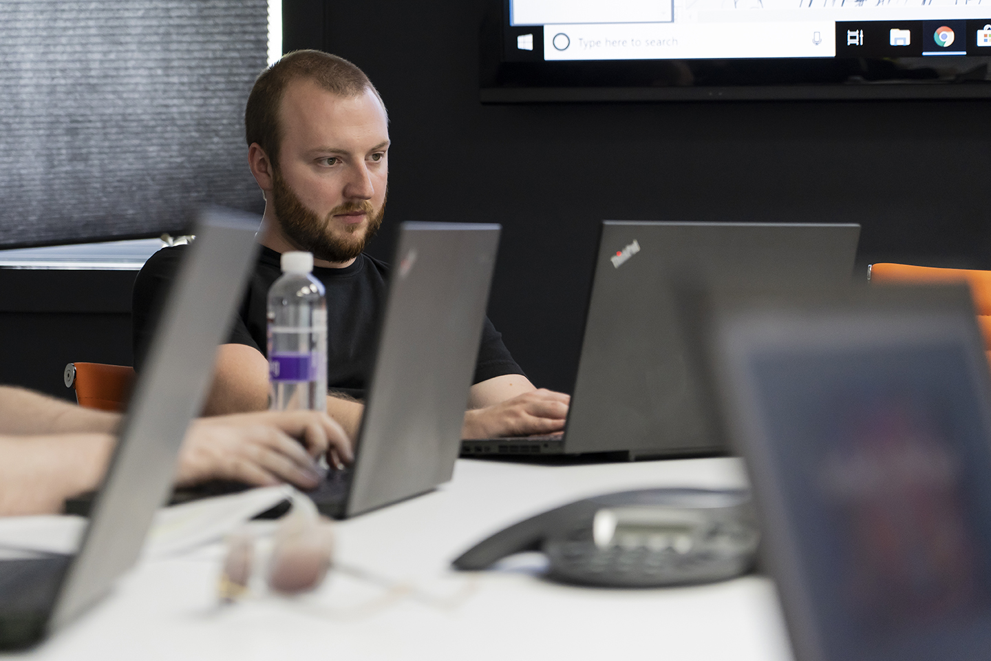 Sean and the Marketing Team working in the conference room at Artonic