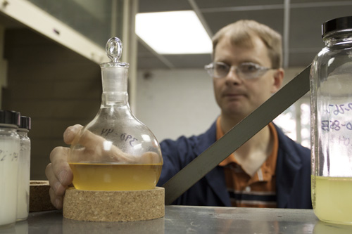 Anderson Development employee looks at chemicals