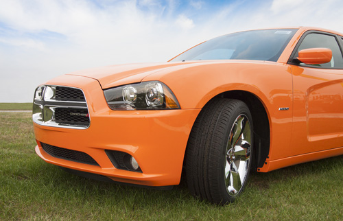 Orange Mustang on the green grass in Michigan