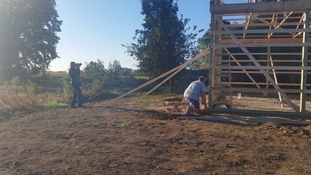 Barn is photographed by woman.