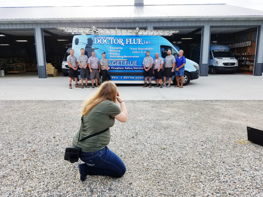 The techs line up in front of a brightly branded van.