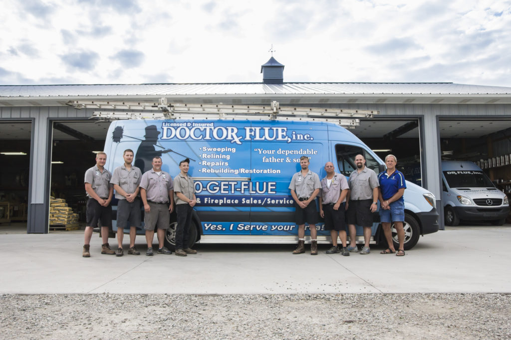 The techs line up in front of a brightly branded van.