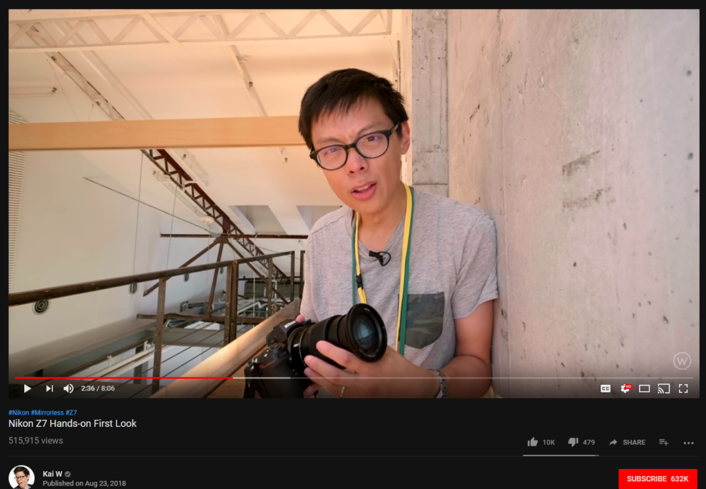 Kai W holds a camera.