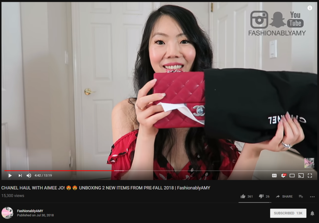 FashionablyAMY shows off a Chanel handbag.