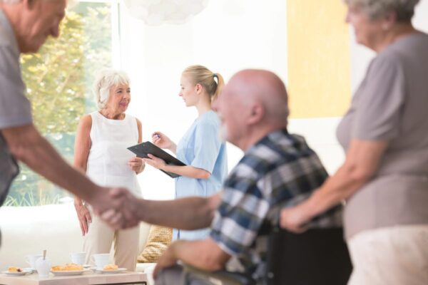 a group of seniors having a meal in a senior living community